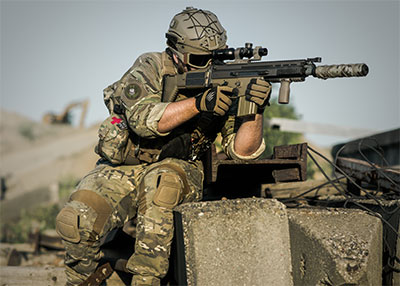 Soldier wearing Level III body armor plate carriers and tactical helmet
